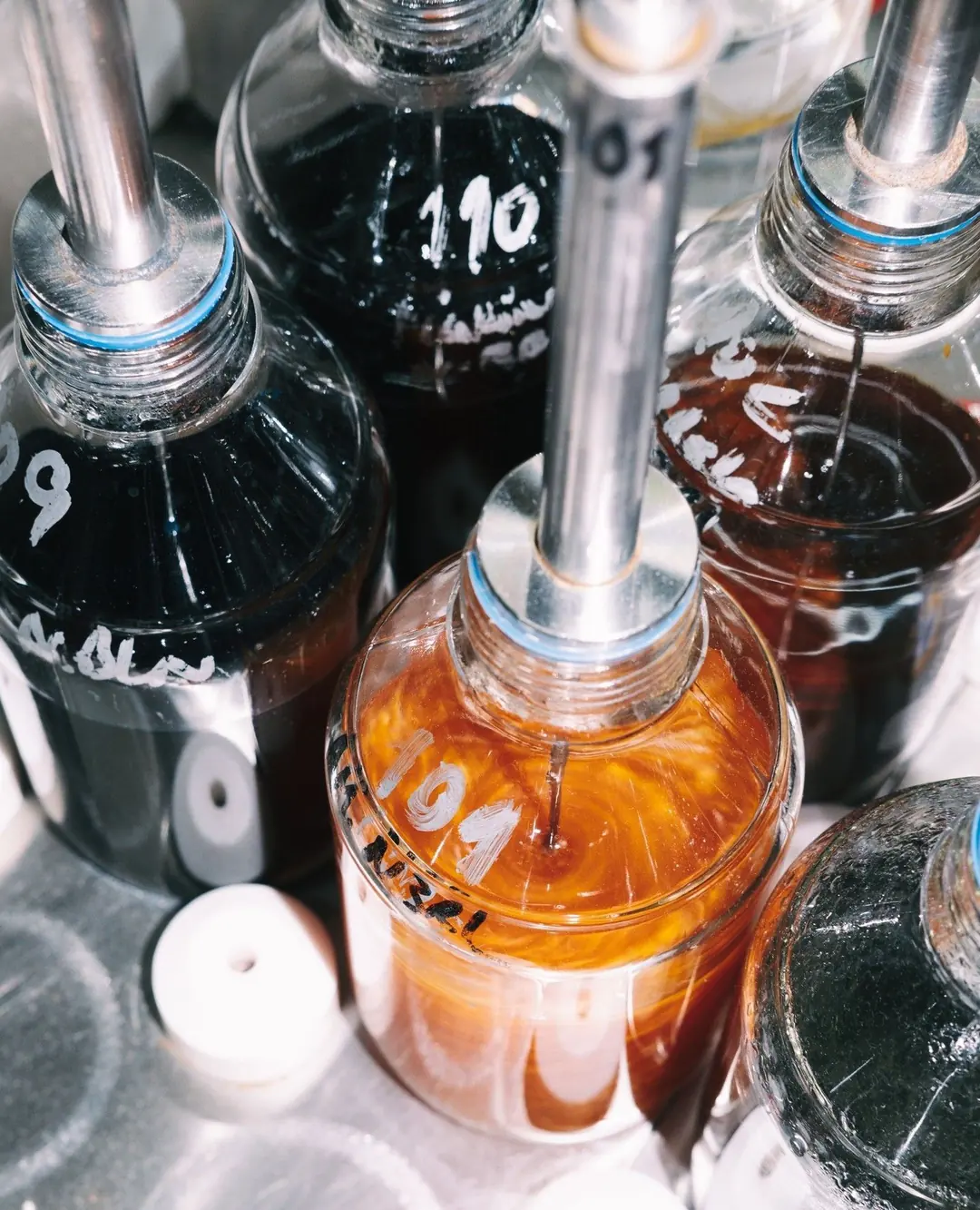 Numbered bottles of screen-printing ink on a mixing station
